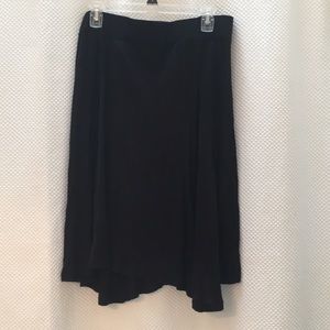 Loose, knee length black skirt. NEVER WORN